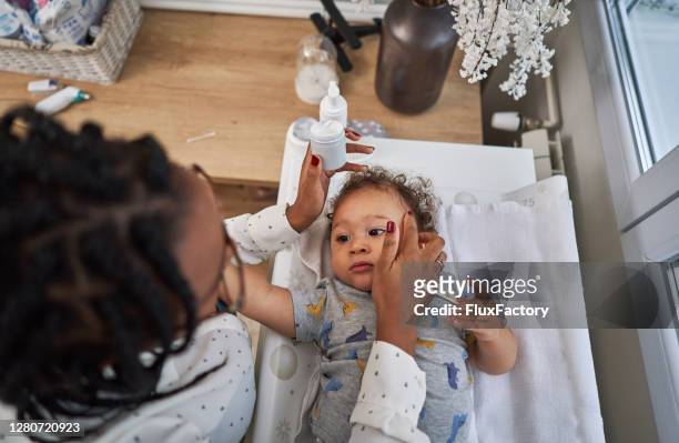 skin care after bath is our everyday routine, so his skin can be soft and smooth - eczema stock pictures, royalty-free photos & images