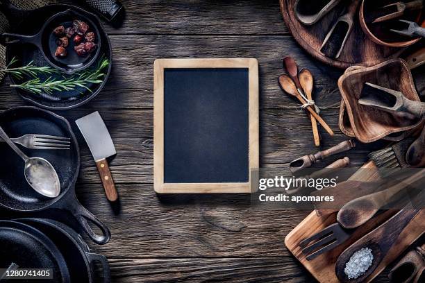 top view of wooden kitchen utensils on rustic table with a board and copy space. - food table edge stock pictures, royalty-free photos & images