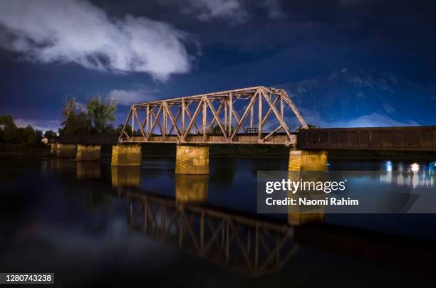 night view of kamloops cn railway swing bridge reflecting in south thompson river - canada - truss bridge stock pictures, royalty-free photos & images