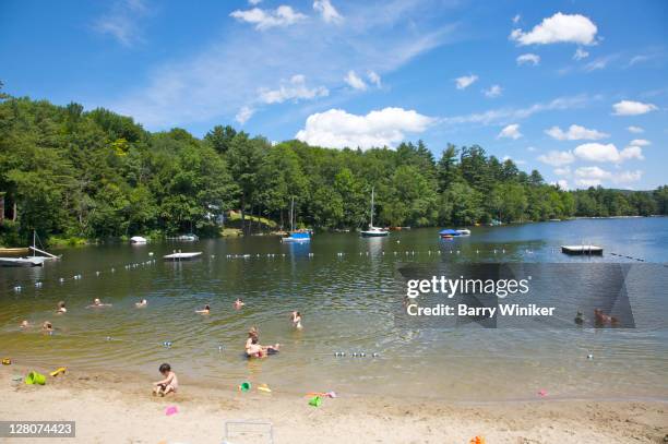 people swimming and boating at beach during summer day, lake garfield, monterey, berkshire county, massachusetts, usa - garfield lake stock pictures, royalty-free photos & images