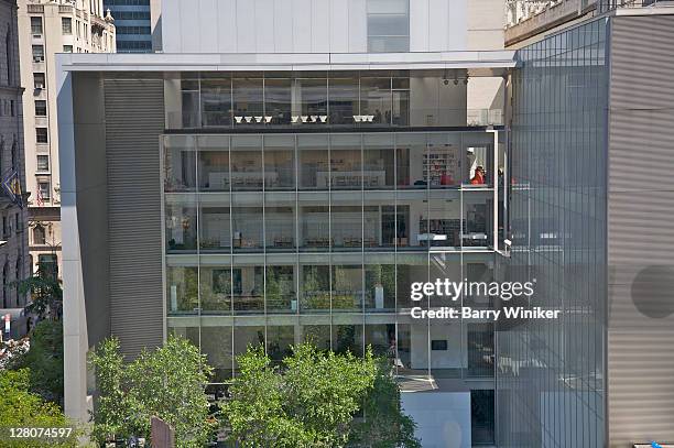 education building at the museum of modern art, new york, ny above trees from the sculpture garden - new york city museum of modern art stock-fotos und bilder