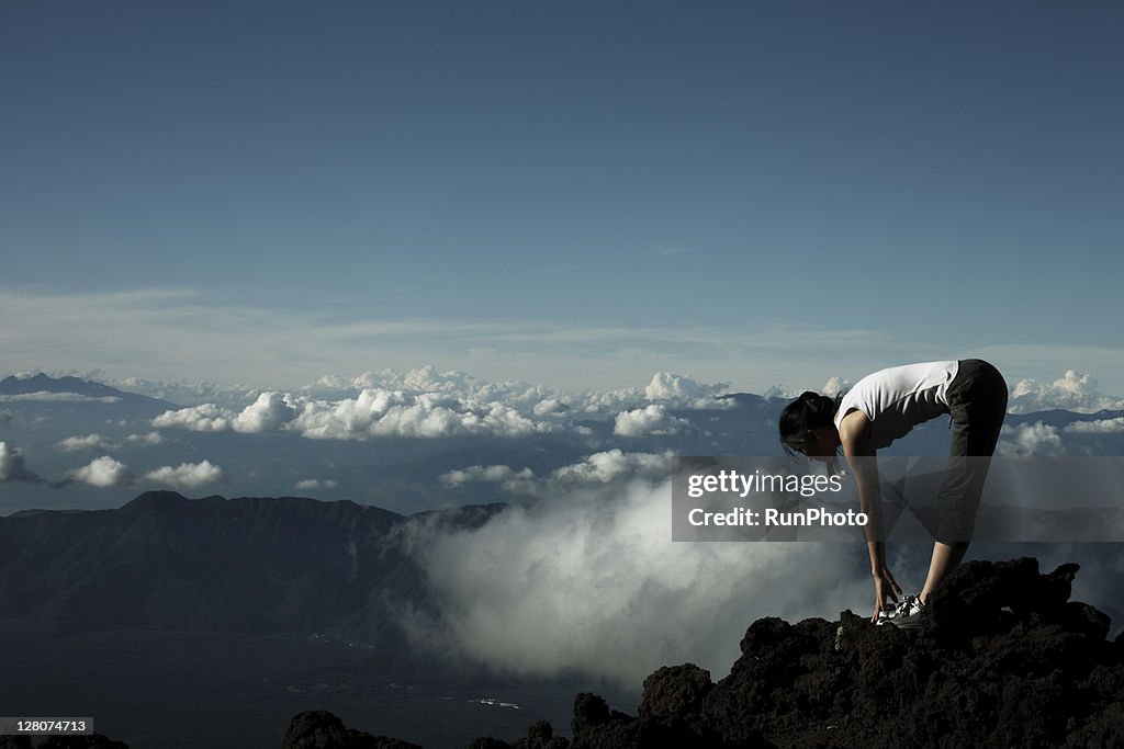 Woman stretching at the mountain