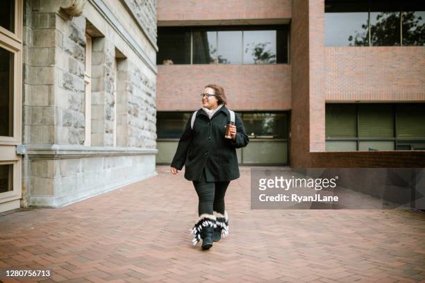 college student walking university campus - fall in seattle stock pictures, royalty-free photos & images