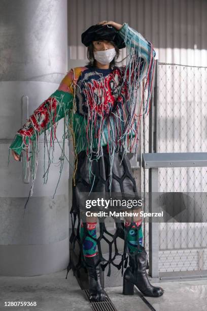 Guest is seen on the street wearing colorful knit Charles Jeffrey Loverboy outfit, shoes and hat during the Rakuten Fashion Week Tokyo 2021...