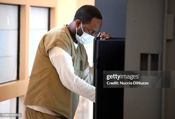 Cook County jail detainee uses a touch screen to cast his votes after a polling place in the facility was opened for early voting on October 17, 2020...