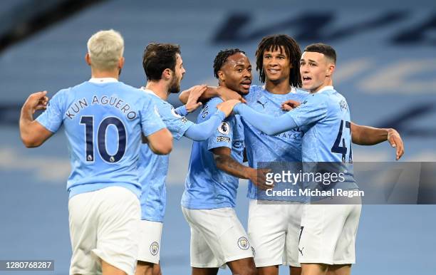 Raheem Sterling of Manchester City celebrates with teammates after scoring his team's first goal during the Premier League match between Manchester...