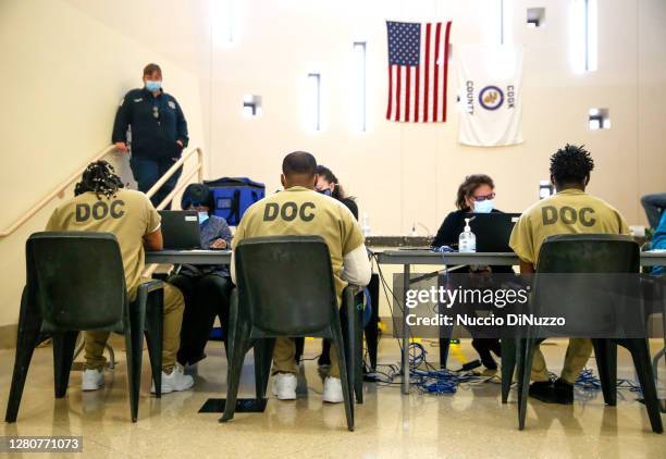 Cook County jail detainees check in before casting their votes after a polling place was opened in the facility for early voting on October 17, 2020...