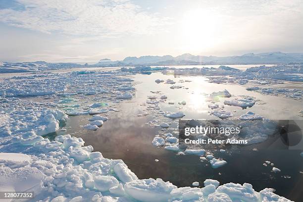 tiniteqilaaq and sea ice in winter, e. greenland - east stock pictures, royalty-free photos & images