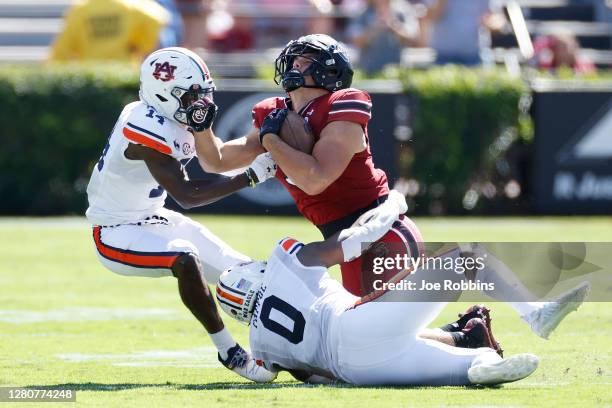 Nehemiah Pritchett and Owen Pappoe of the Auburn Tigers tackle Nick Muse of the South Carolina Gamecocks in the second quarter of the game at...