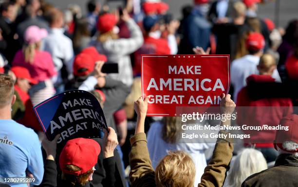 Bern Township, PA People in the crowd hold Make America Great Again signs. At the Reading Regional Airport in Bern township Saturday October 17, 2020...