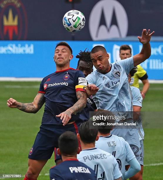 Francisco Calvo of Chicago Fire and Winston Reid of Sporting Kansas City jump for a header on a corner kick at Soldier Field on October 17, 2020 in...