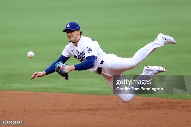 Enrique Hernandez of the Los Angeles Dodgers attempts to throw out the runner against the Atlanta Braves during the second inning in Game Six of the...