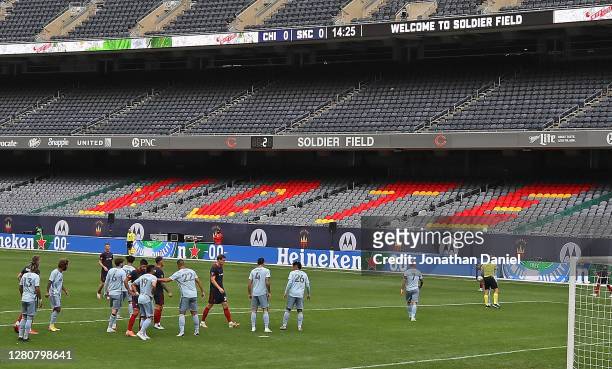 Members of the Chicago Fire and Sporting Kansas City play in front of a sign that encourages viewers to vote at Soldier Field on October 17, 2020 in...