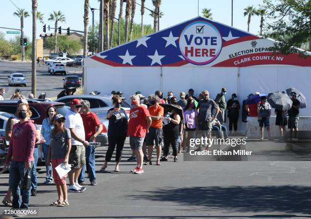 People line up to vote at a shopping center on the first day of in-person early voting on October 17, 2020 in Las Vegas, Nevada. Early voting for the...