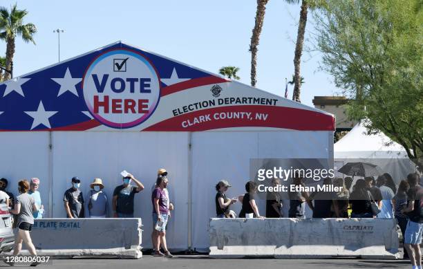 People line up to vote at a shopping center on the first day of in-person early voting on October 17, 2020 in Las Vegas, Nevada. Early voting for the...