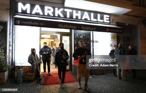 Customers buy beer as a late night shop closes at 11pm on October 17, 2020 in Berlin, Germany. About 11 bars and restaurants in city led a successful...