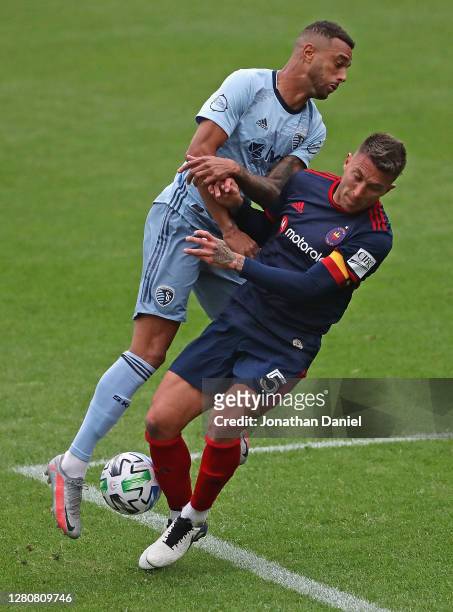 Khiry Shelton of Sporting Kansas City collides with Francisco Calvo of Chicago Fire at Soldier Field on October 17, 2020 in Chicago, Illinois....