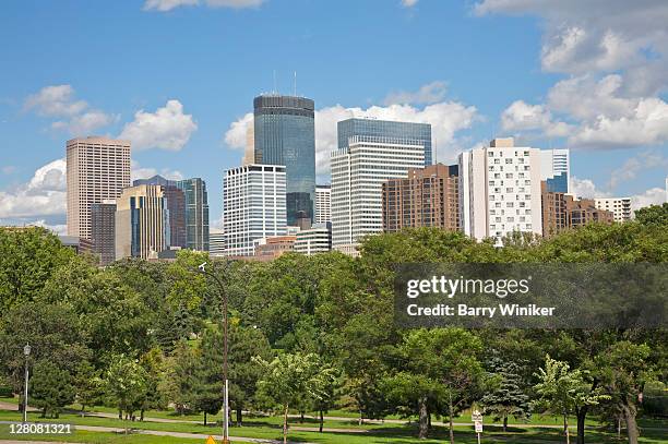 skyline with downtown office skyscrapers above trees of loring park, minneapolis, minnesota, midwest, usa - minneápolis fotografías e imágenes de stock