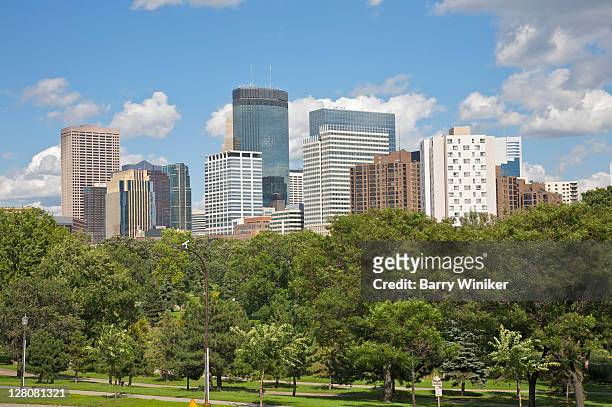 skyline with downtown office skyscrapers above trees of loring park, minneapolis, minnesota, midwest, usa - minneapolis foto e immagini stock