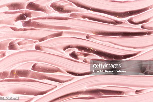 smears of gel on pink background - smörjning bildbanksfoton och bilder