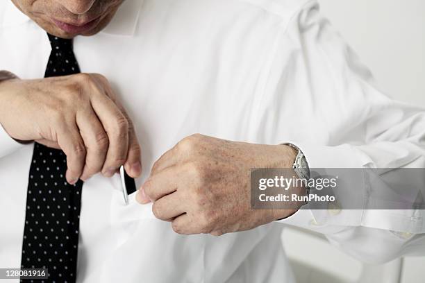 old age businessmen putting a pen in the pocket - shirt pocket stock pictures, royalty-free photos & images
