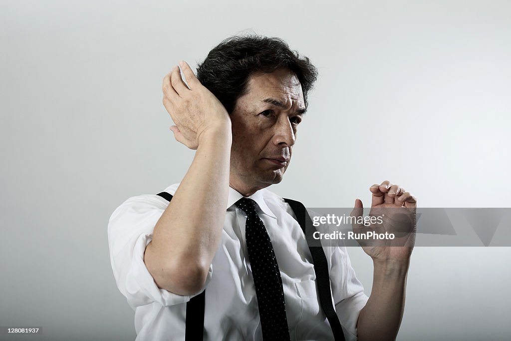 Old age businessman adjusting his hair