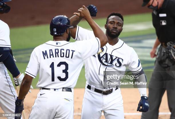 Randy Arozarena of the Tampa Bay Rays celebrates a two run home run against the Houston Astros with teammate Manuel Margot during the first inning in...