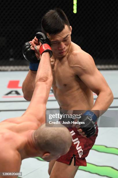 Brian Ortega punches ‘The Korean Zombie’ Chan Sung Jung in their featherweight bout during the UFC Fight Night event inside Flash Forum on UFC Fight...