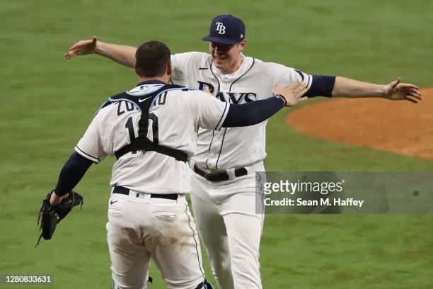 Peter Fairbanks and Mike Zunino of the Tampa Bay Rays celebrate a 4-2 win against the Houston Astros to win the series in Game Seven of the American...