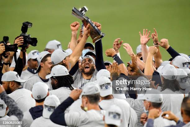 Members of the Tampa Bay Rays hold the William Harridge Trophy after defeating the Houston Astros in Game Seven of the American League Championship...