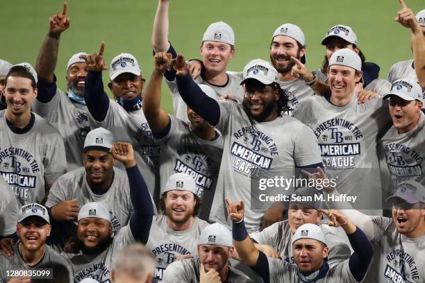 Members of the Tampa Bay Rays pose with the William Harridge Trophy after defeating the Houston Astros in Game Seven of the American League...