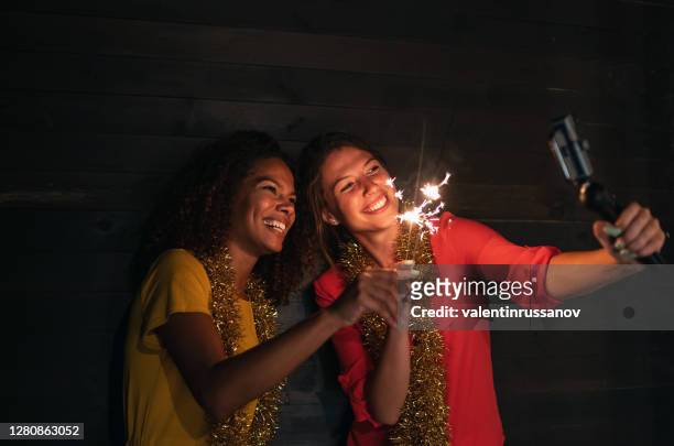 friends teleconferencing and celebrating online new years eve party at home, during covid-19 pandemic - 30 34 years stock pictures, royalty-free photos & images