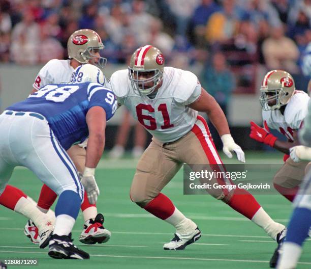 Offensive lineman Jesse Sapolu of the San Francisco 49ers blocks against defensive lineman Tony Siragusa of the Indianapolis Colts during a game at...