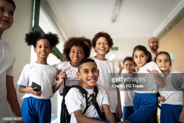 portrait of a happy group of elementary students - private school uniform stock pictures, royalty-free photos & images