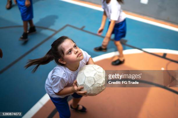 focused student with disability playing basketball - children sport imagens e fotografias de stock