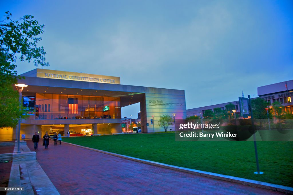People walking on path near facade of new National Constitution Center, on the Independence Mall in Philadelphia, Pennsylvania