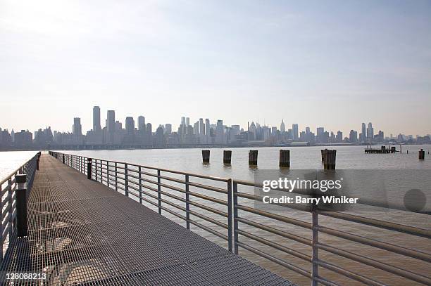 modern steel pier, hudson river towards manhattan, the landings at port imperial, weehawken, new jersey, usa, march 2010 - steel railings stock pictures, royalty-free photos & images