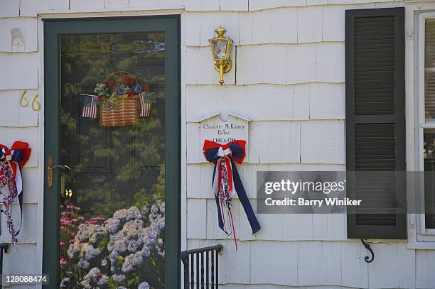 ribbons, flowers, flag, basket on front of historic house in stony brook, ny, u.s.a. - stony brook stock pictures, royalty-free photos & images