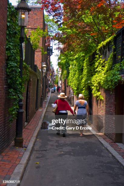 two people walking up a back street on garden tours, beacon hill, bsoston, ma - beacon hill stock pictures, royalty-free photos & images