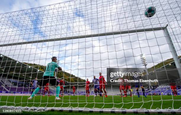 Malcolm Cacutalua of Aue scores his team's first goal past goalkeeper Kevin Mueller of Heidenheim during the Second Bundesliga match between FC...