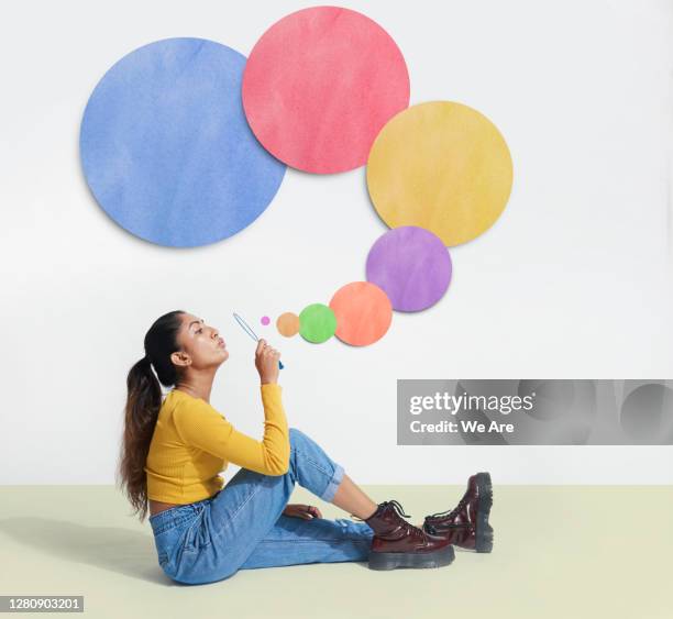 woman blowing bubbles - bubble wand foto e immagini stock