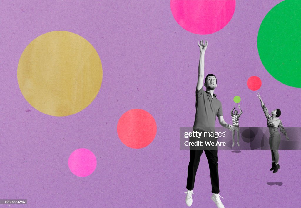 Three people jumping for bubbles