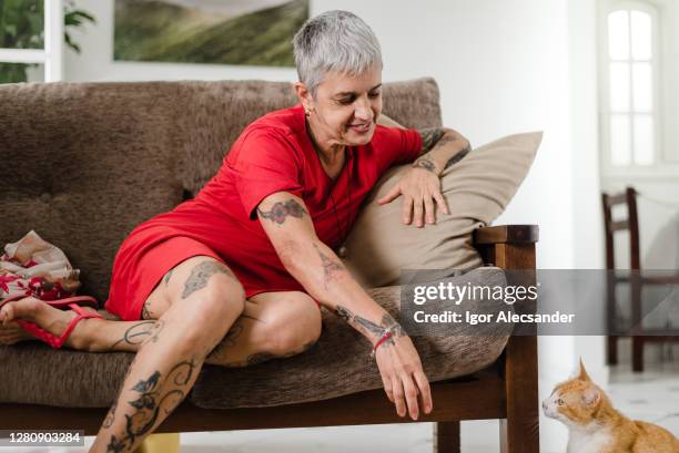 relaxed at home with the kitten - old woman tattoos stock pictures, royalty-free photos & images