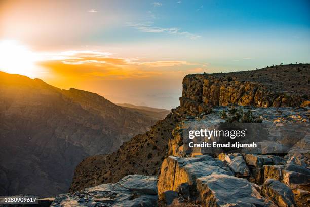 golden sunset over the highest peak of jebel shams, (mountain of the sun), al hamra, oman - oman landscape stock pictures, royalty-free photos & images