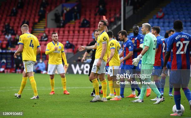 Referee Stuart Attwell awards Lewis Dunk of Brighton and Hove Albion a red card during the Premier League match between Crystal Palace and Brighton &...