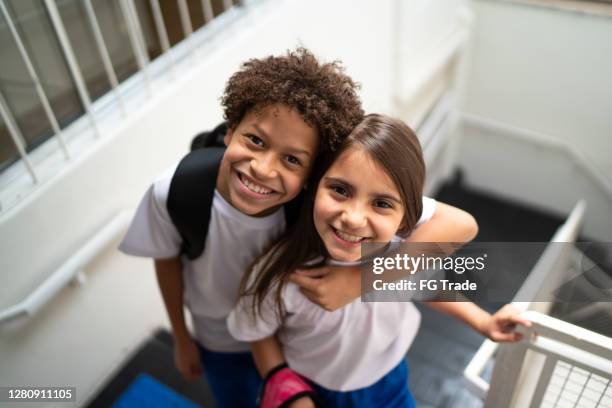 portrait of two elementary students at school - private school uniform stock pictures, royalty-free photos & images