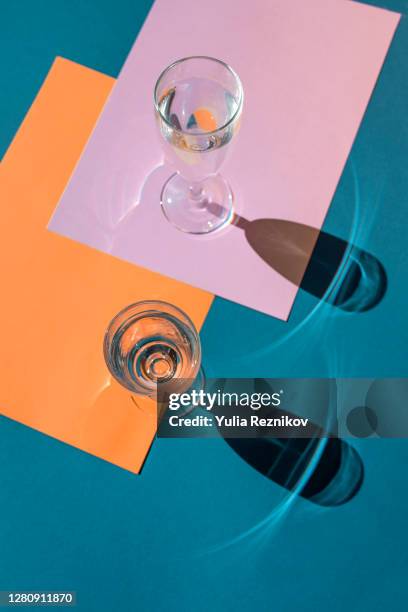 water in glas on the colorful background - champagne glass stockfoto's en -beelden