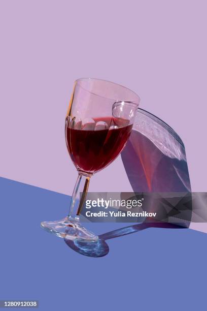 wine glass on the purple-blue background - alcohol abuse stock pictures, royalty-free photos & images