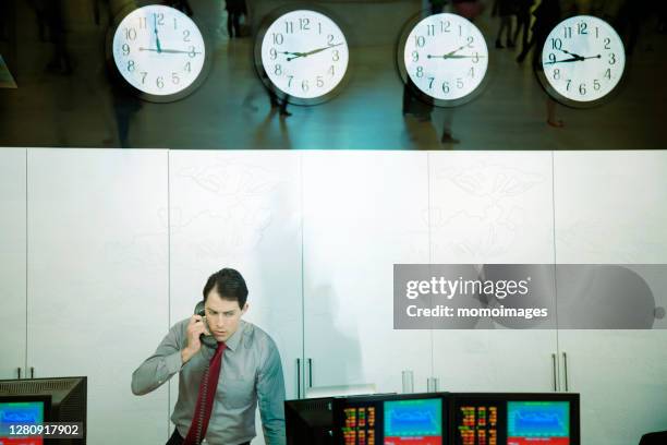 trader working in trading room - stockbrokers stock pictures, royalty-free photos & images