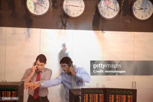 two traders working in trading room - trading floor stock pictures, royalty-free photos & images